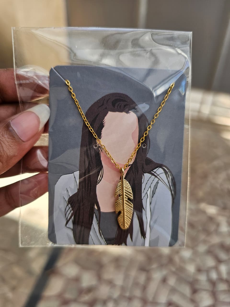 Gold feather pendant chain